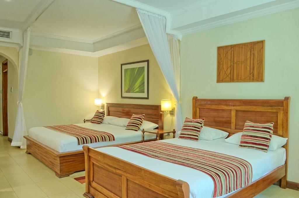 Postel nebo postele na pokoji v ubytování Sovereign Hotel