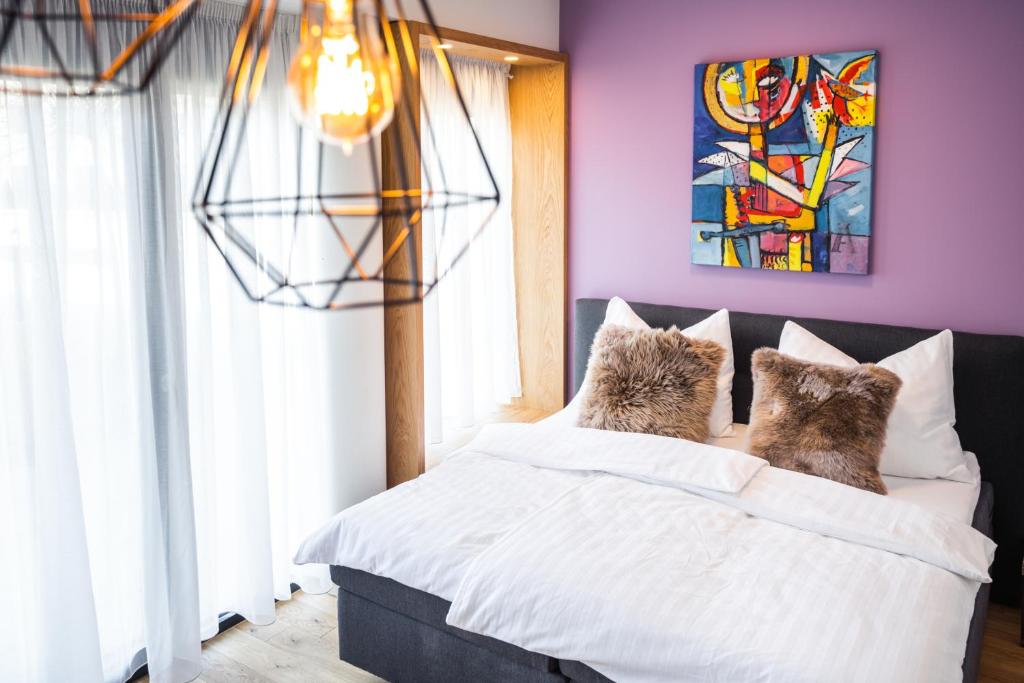 Кровать или кровати в номере Kaiser Apartments - Wohnpark Graz-Gösting