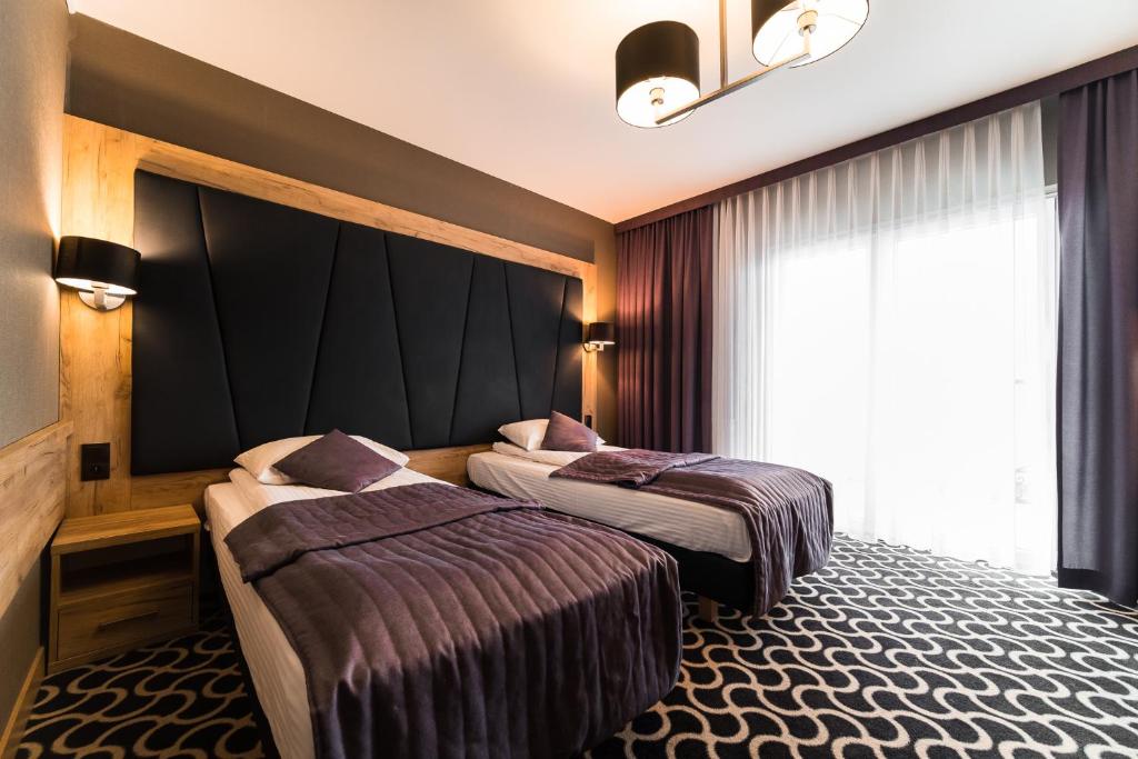 Postel nebo postele na pokoji v ubytování Hotel Coloseum