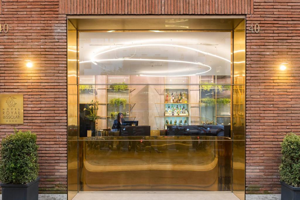 a glass door of a store with a person sitting at a desk at Hotel Royal Bissolati in Rome