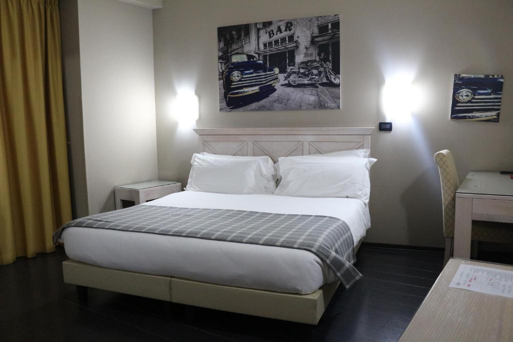 Postel nebo postele na pokoji v ubytování Hotel Garibaldi