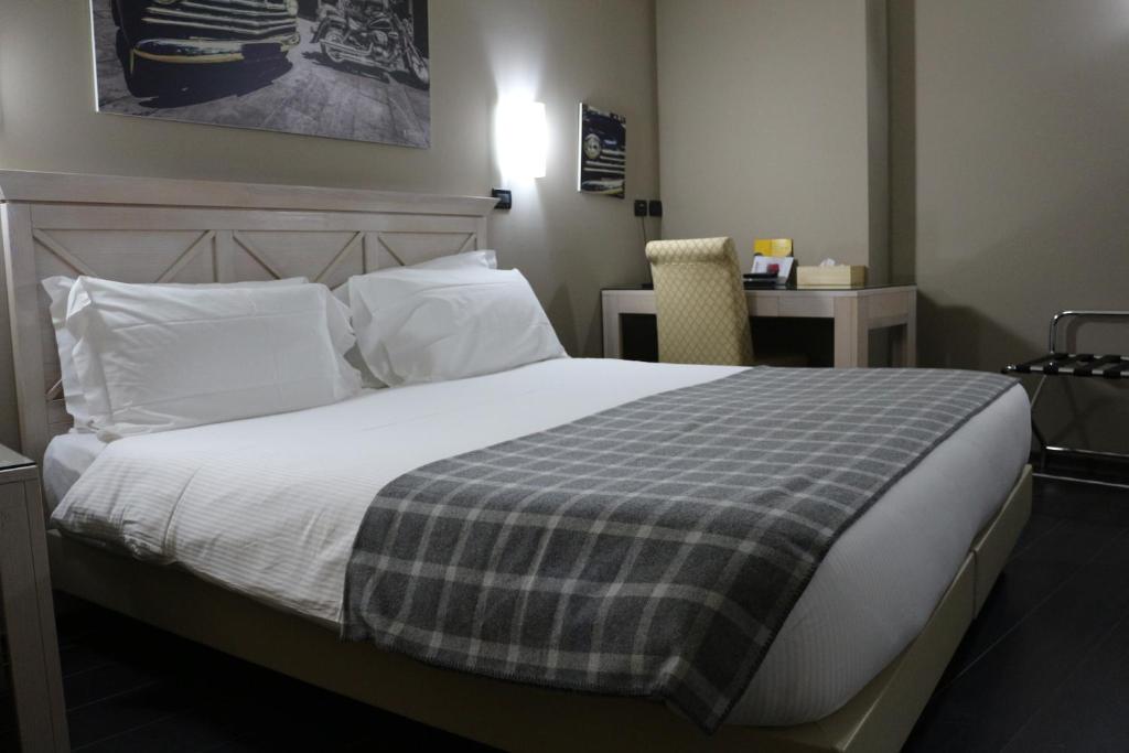 Postel nebo postele na pokoji v ubytování Hotel Garibaldi