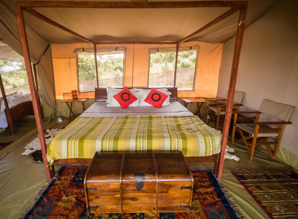 a bedroom with a bed in a tent at Oldarpoi Wageni Camp in Sekenani