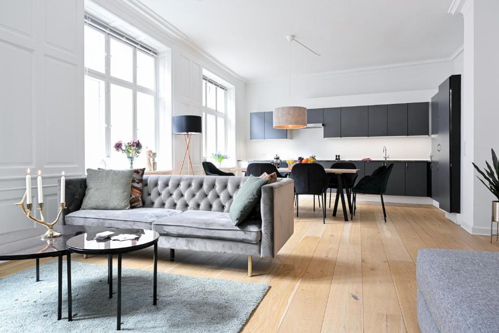 a living room with a couch and a table at Sanders Arrow - Chic Three-Bedroom Apartment In the Middle of Copenhagen in Copenhagen