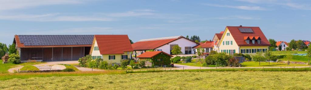 a group of houses in a field next to a field at Ferienhof Lecheler in Breitenthal