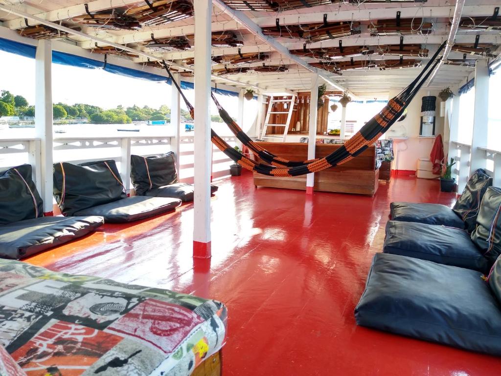 a room with couches and a hammock on a boat at Selvagem Tours in Alter do Chao