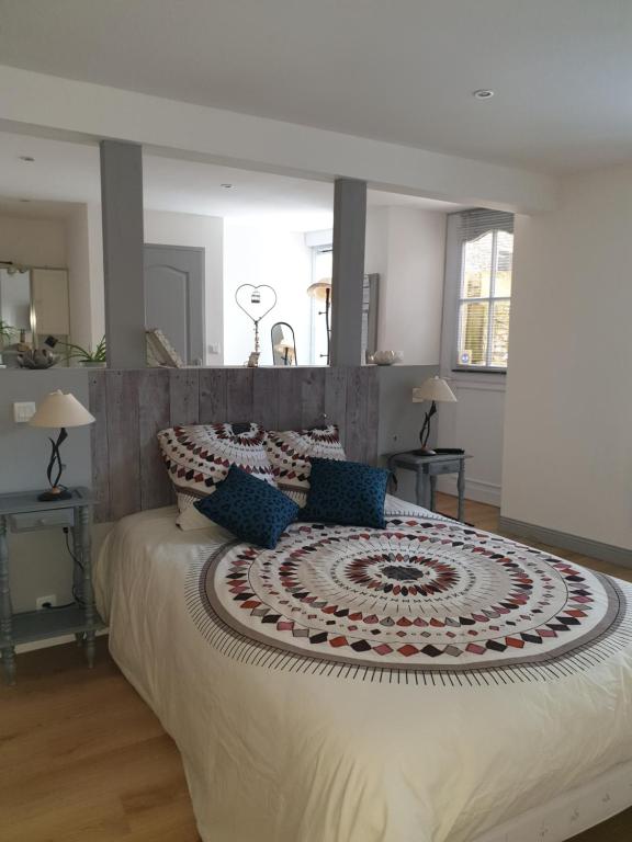 a bedroom with a large bed with a large rug on it at La jolie chambre in Javrezac