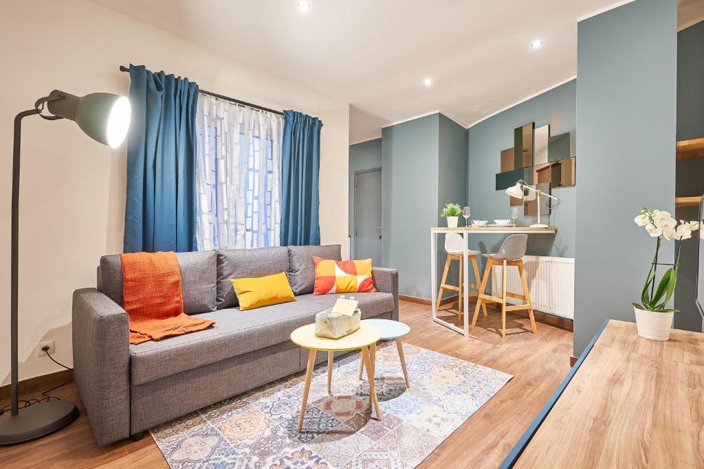 a living room with a couch and a table at Downtown Brussels Studio in Brussels