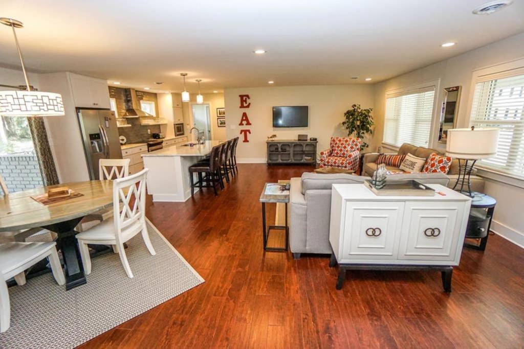 a kitchen and living room with a couch and a table at Beautiful, Modern Getaway in Historic Downtown Beaufort in Beaufort