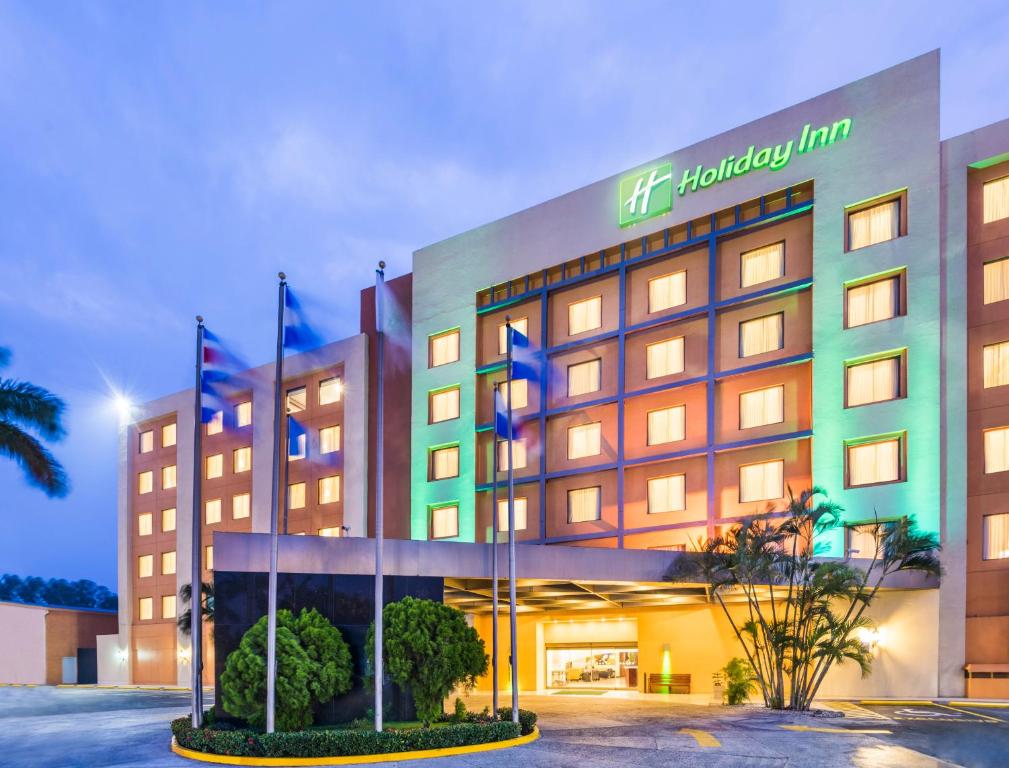 a hotel with flags in front of a building at Holiday Inn Convention Center, an IHG Hotel in Managua