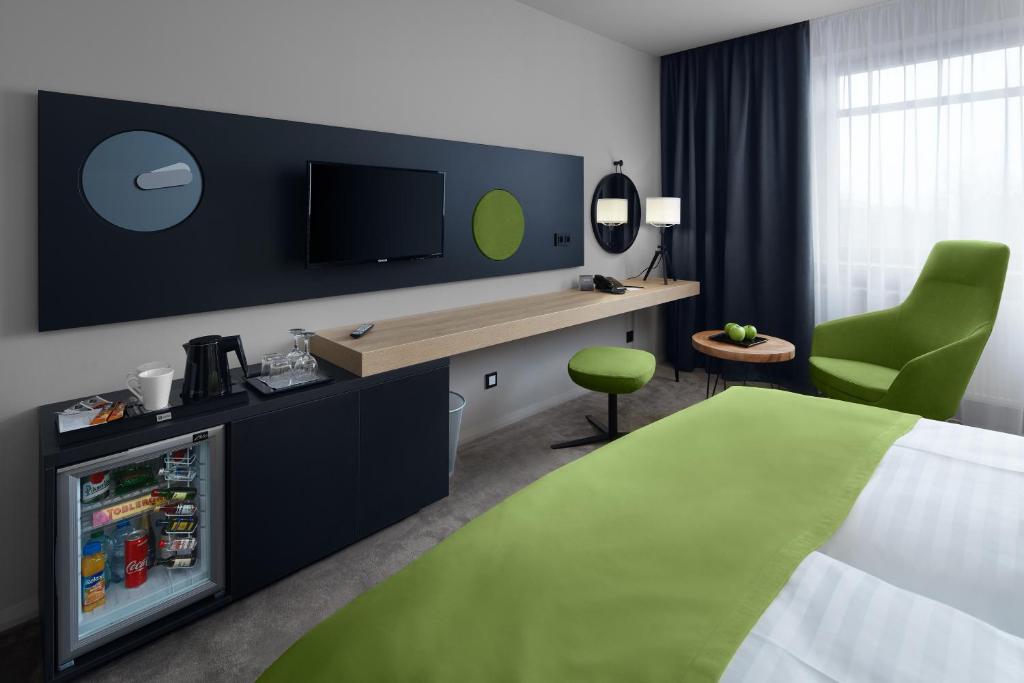 a hotel room with a bed and a television at Spa Hotel Felicitas in Poděbrady