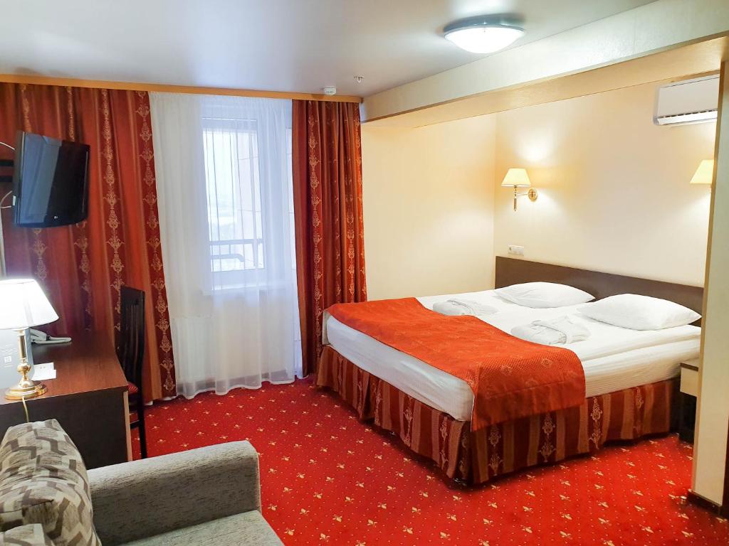 Postel nebo postele na pokoji v ubytování AMAKS Safar Hotel