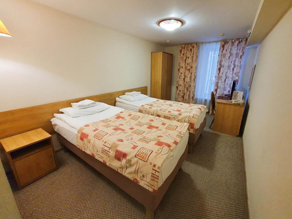Postel nebo postele na pokoji v ubytování AMAKS Safar Hotel