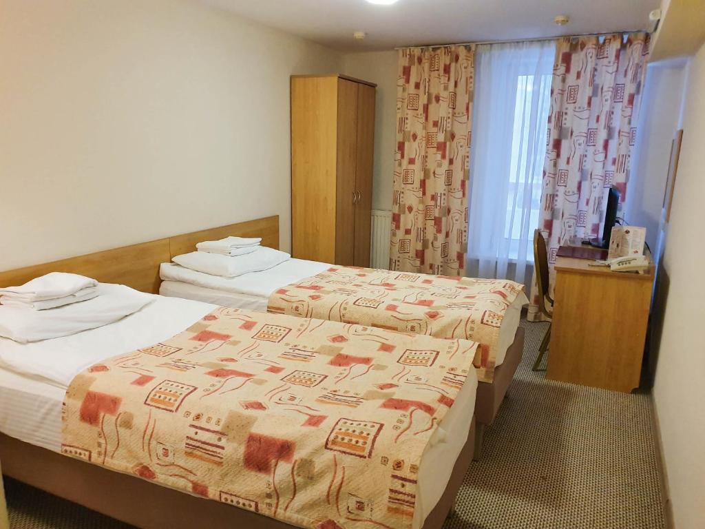 Postel nebo postele na pokoji v ubytování AMAKS Safar Hotel