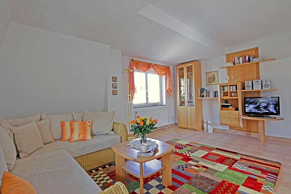 a living room with a couch and a table at Villa Seestern _ Wohnung 10 in Neuhof