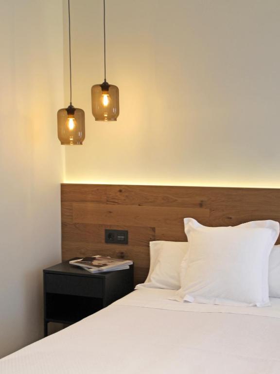 A bed or beds in a room at Hotel Boutique Astorga