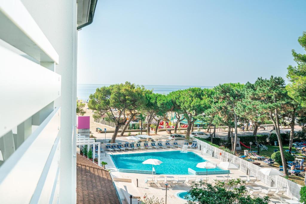 a view of the pool from the balcony of a hotel at Hotel Bristol in Lignano Sabbiadoro