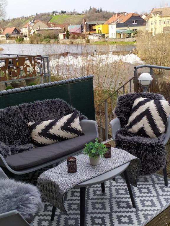 a patio with a couch and two chairs and a table at Palais Picard Ostflügel in Thale