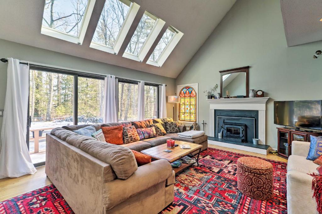 a living room with a couch and a fireplace at Peaceful Goshen Cottage with Screened Porch and Views! in Goshen
