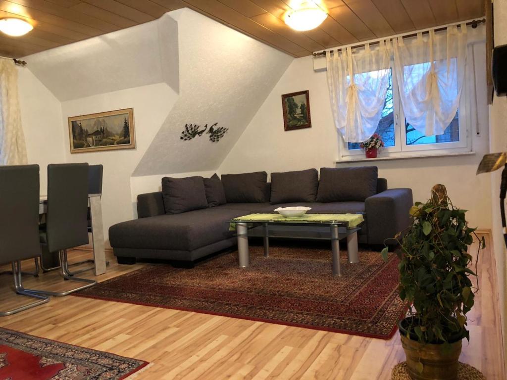 a living room with a couch and a table at Ferienwohnung Bodensee LA in Langenargen