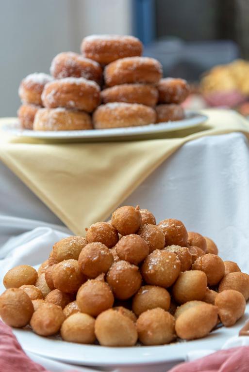 a pile of donuts on a plate on a table at Kordistos Hotel in Kefalos