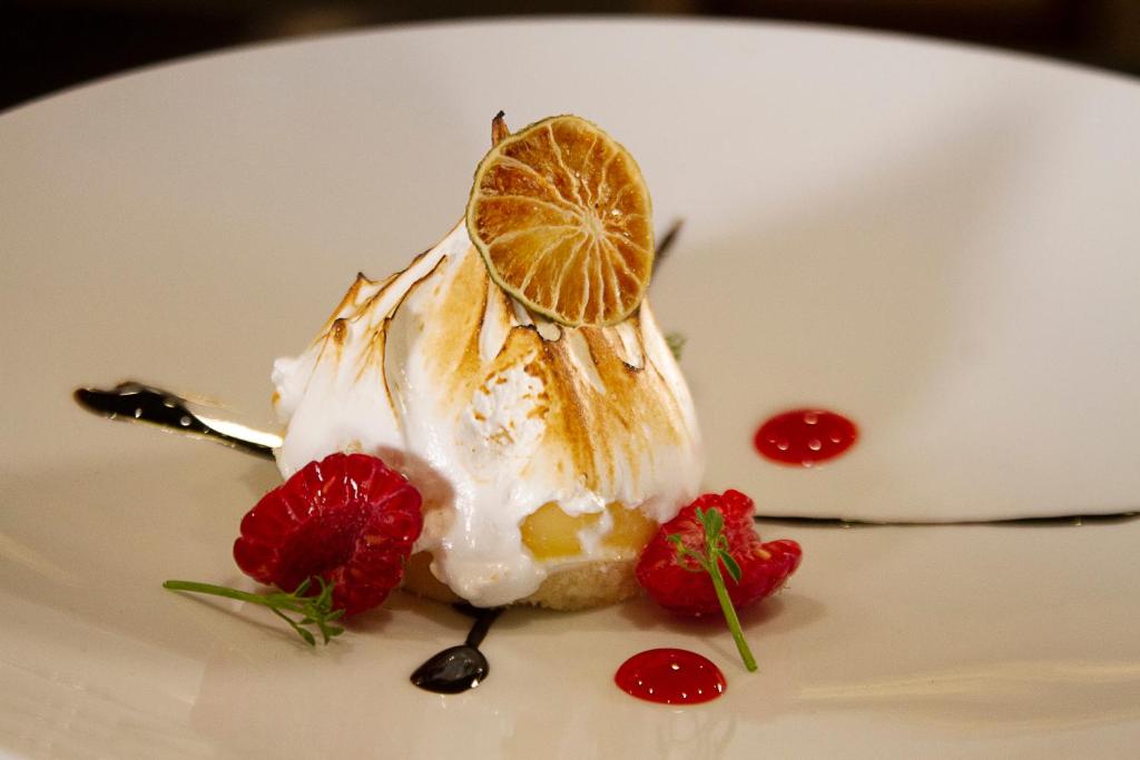 a dessert with whipped cream and strawberries on a white plate at Crowne Plaza Hotel Monterrey by IHG in Monterrey