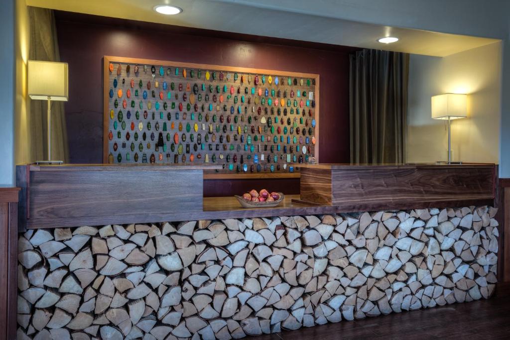 a lobby with a wall of wood logs at The Redwood Riverwalk, a boutique hotel in Fortuna