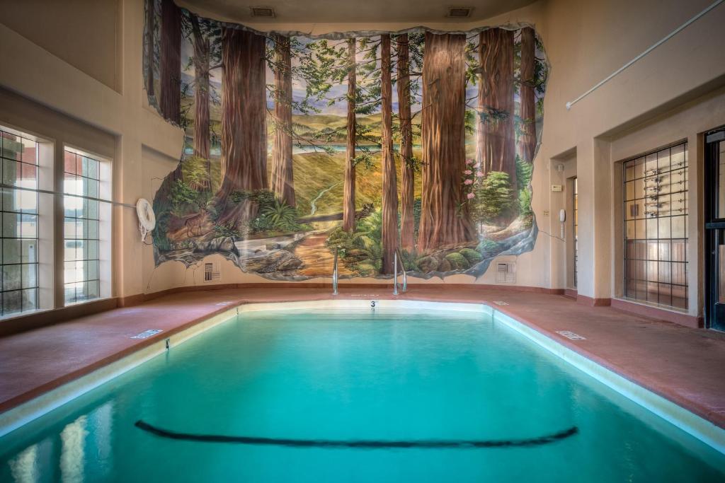 a swimming pool with a mural on the wall at The Redwood Riverwalk, a boutique hotel in Fortuna