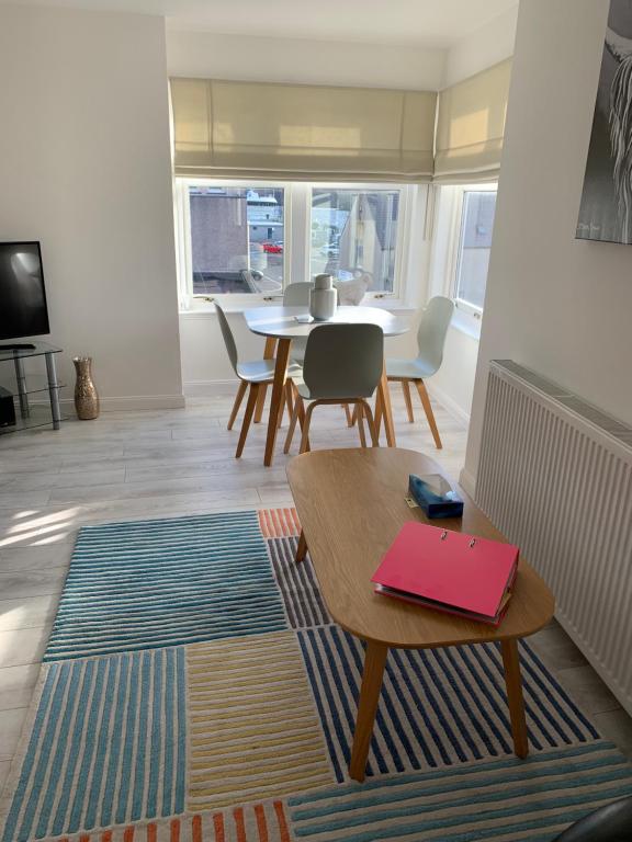 a living room with a table and chairs at No.10 in Stornoway