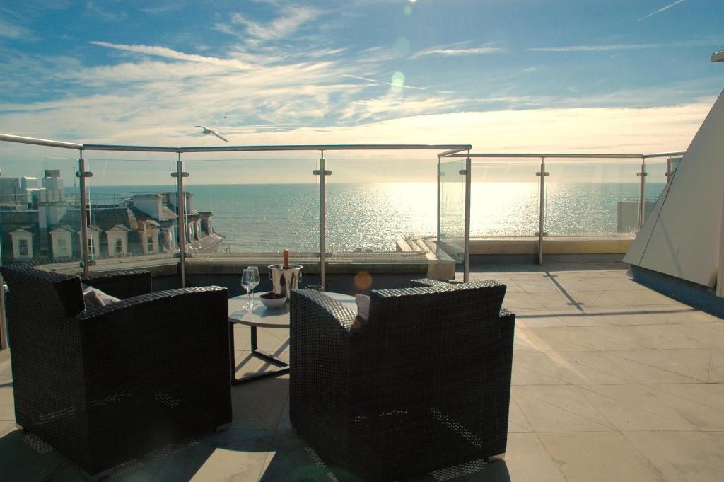 a balcony with a view of the ocean at Green Diamond by Creatick Apartments in Brighton & Hove