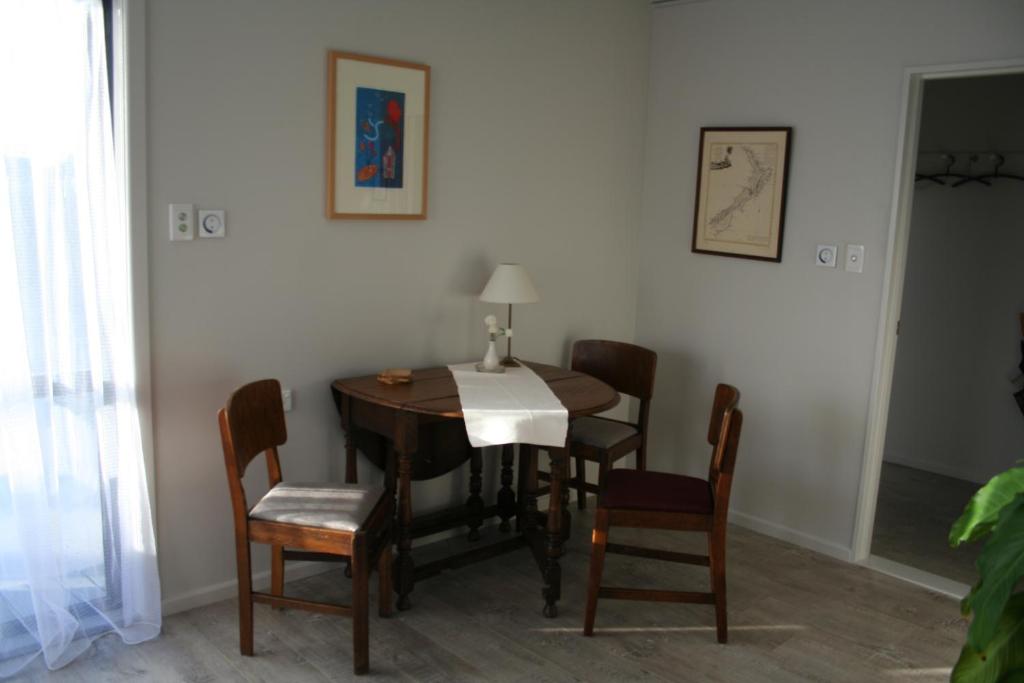 a dining room with a table and chairs at AHAVA Bed & Breakfast in Waimate