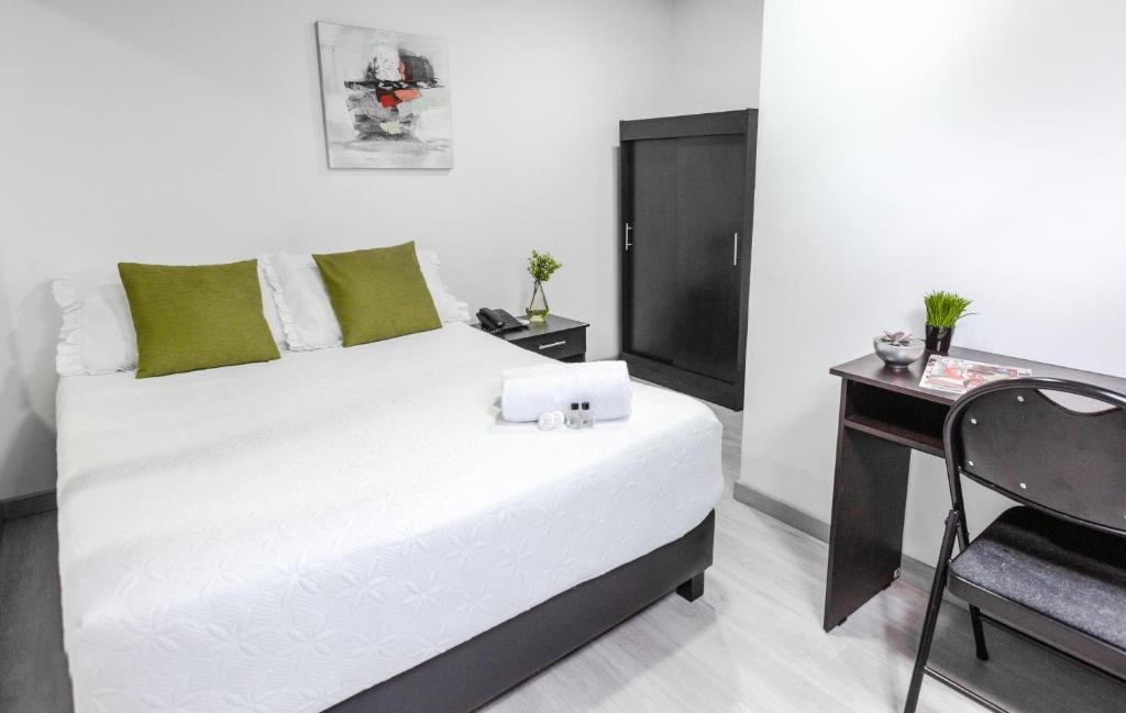 Postel nebo postele na pokoji v ubytování Hotel Casa Quinta Embajada