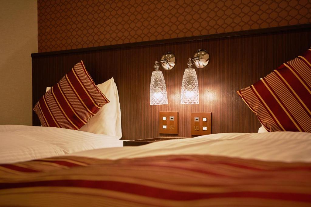 Postel nebo postele na pokoji v ubytování Hotel Amaterrace Yosuga