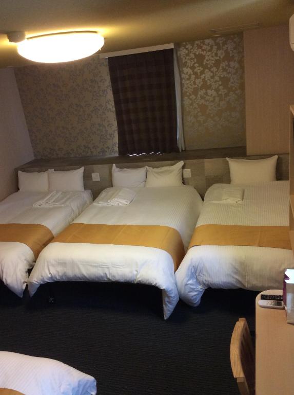 Postel nebo postele na pokoji v ubytování Hotel AreaOne Izumo