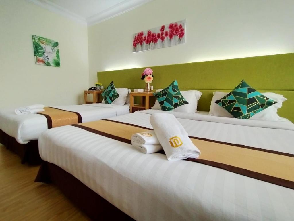 Postel nebo postele na pokoji v ubytování Tang Dynasty Hotel