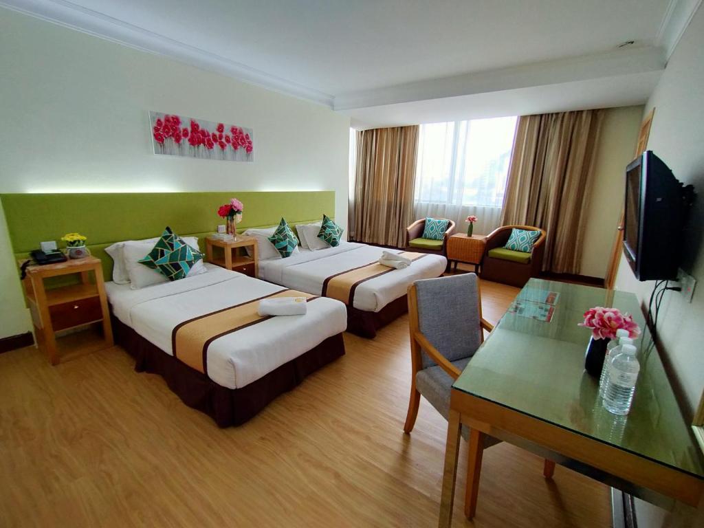 Postel nebo postele na pokoji v ubytování Tang Dynasty Hotel