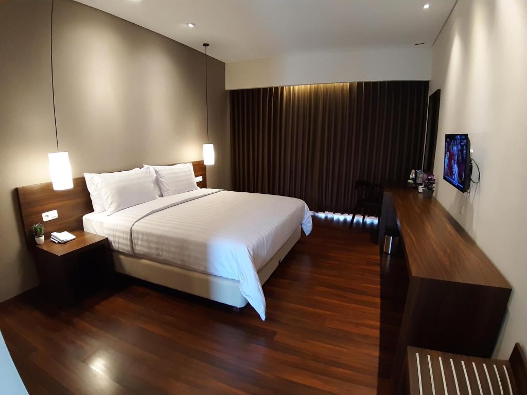 En eller flere senger på et rom på PEPABRI Hotel & Resort