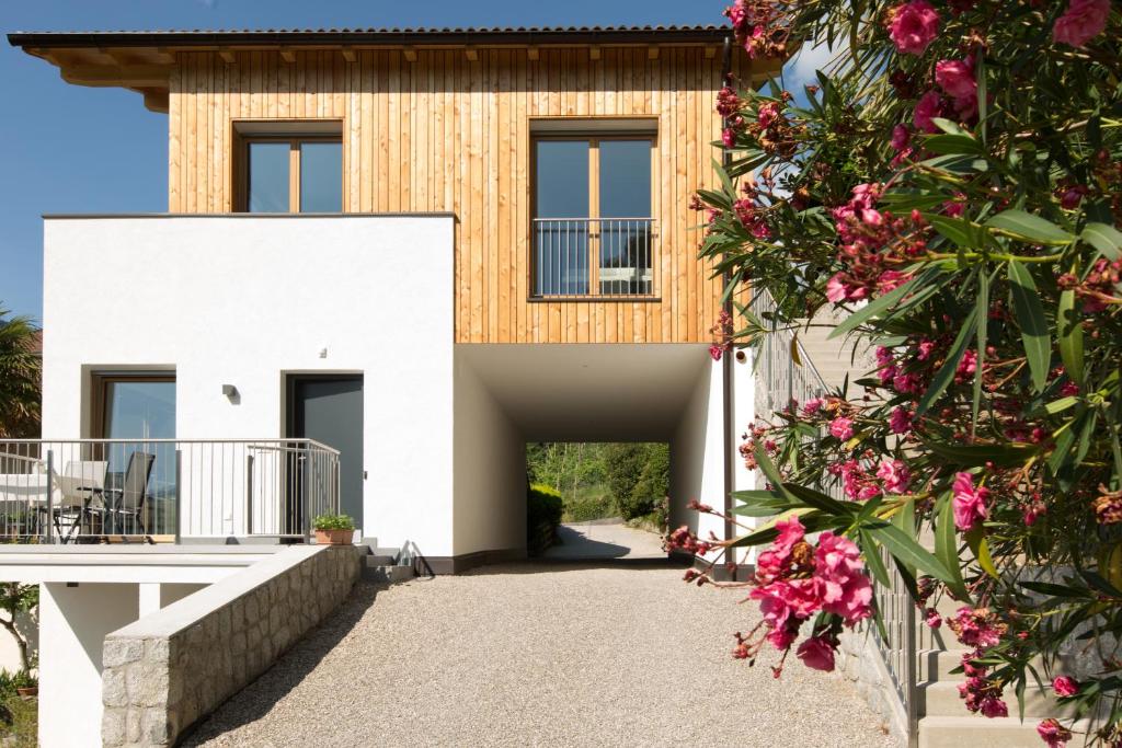 a white house with flowers in front of it at Appartements Martinsheim in Tirolo