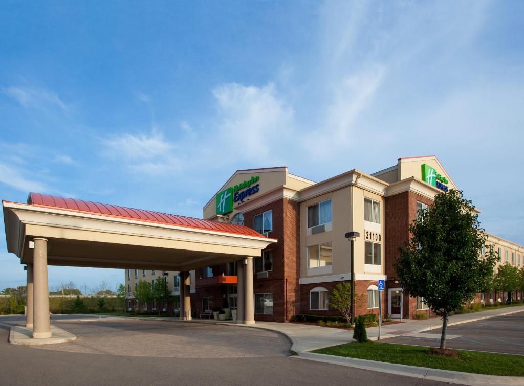 a large building with a clock on the front of it at Holiday Inn Express Hotel & Suites Detroit - Farmington Hills, an IHG Hotel in Northville