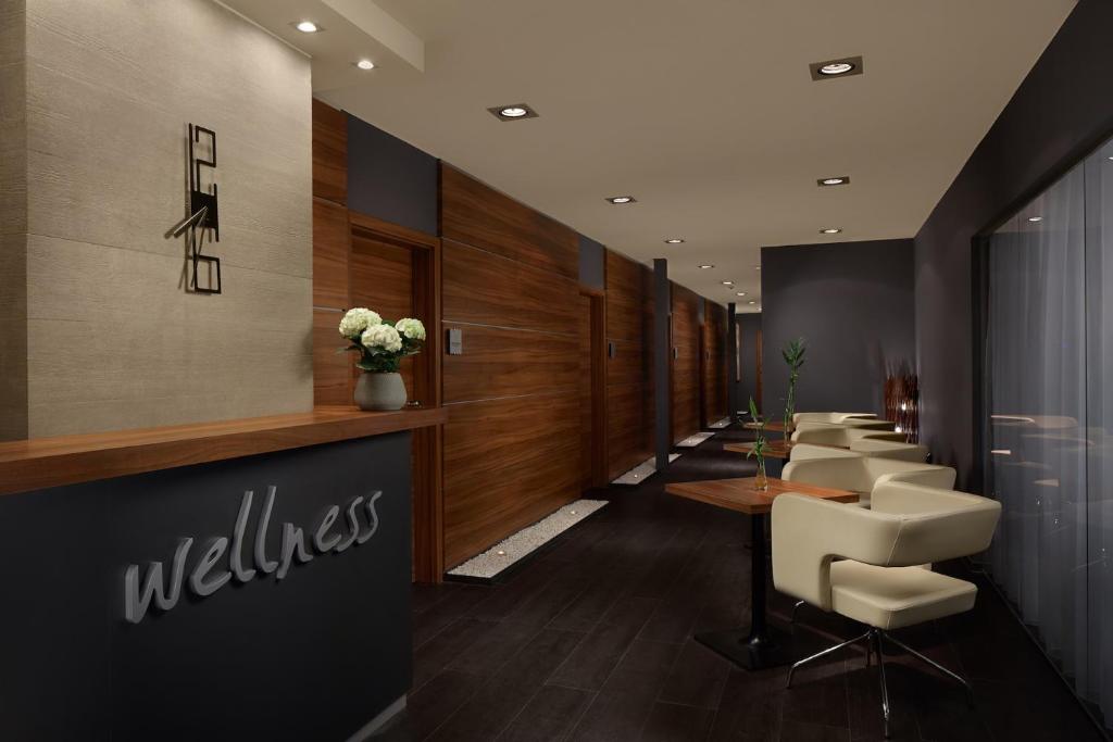 a waiting room with a row of white chairs at Spa Hotel Felicitas in Poděbrady