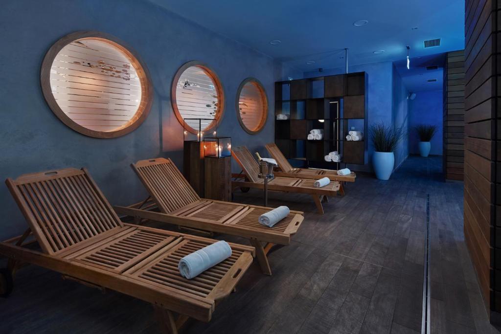 a living room with three chairs and circular mirrors at Spa Hotel Felicitas in Poděbrady