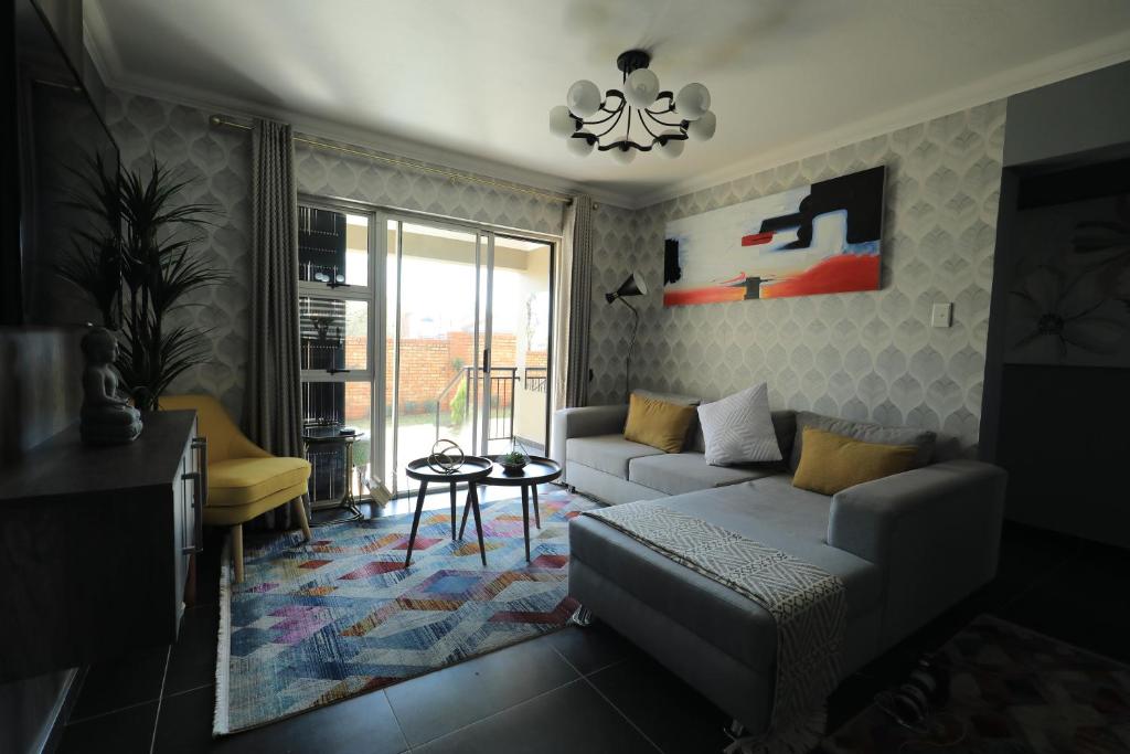 een woonkamer met een bank en een tafel bij The View - Luxury Apartment in Witbank