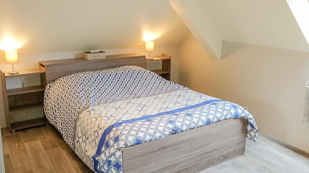 a bedroom with a bed in a room with two lights at Le Familial in Kintzheim