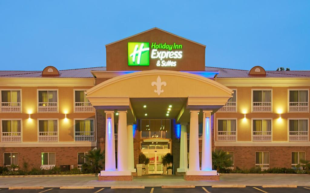 a woman standing in front of a building with a clock on it at Holiday Inn Express & Suites Alexandria, an IHG Hotel in Alexandria