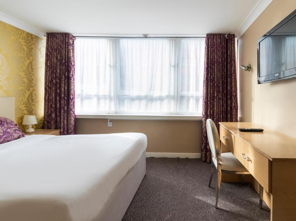 Postel nebo postele na pokoji v ubytování Stuart Hotel