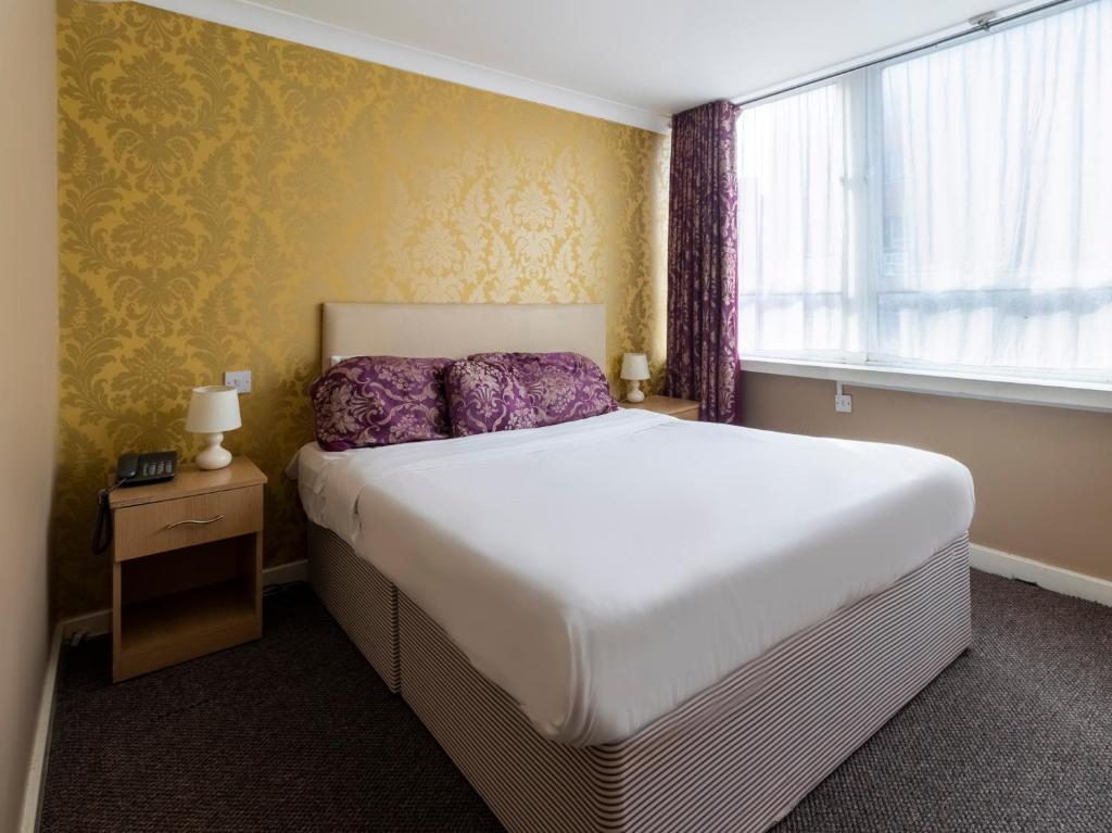 Postel nebo postele na pokoji v ubytování Stuart Hotel
