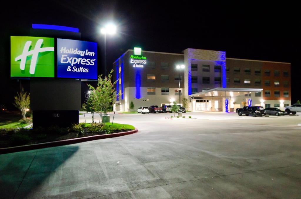 a sign in a parking lot in front of a hospital at Holiday Inn Express & Suites Taylor, an IHG Hotel in Taylor