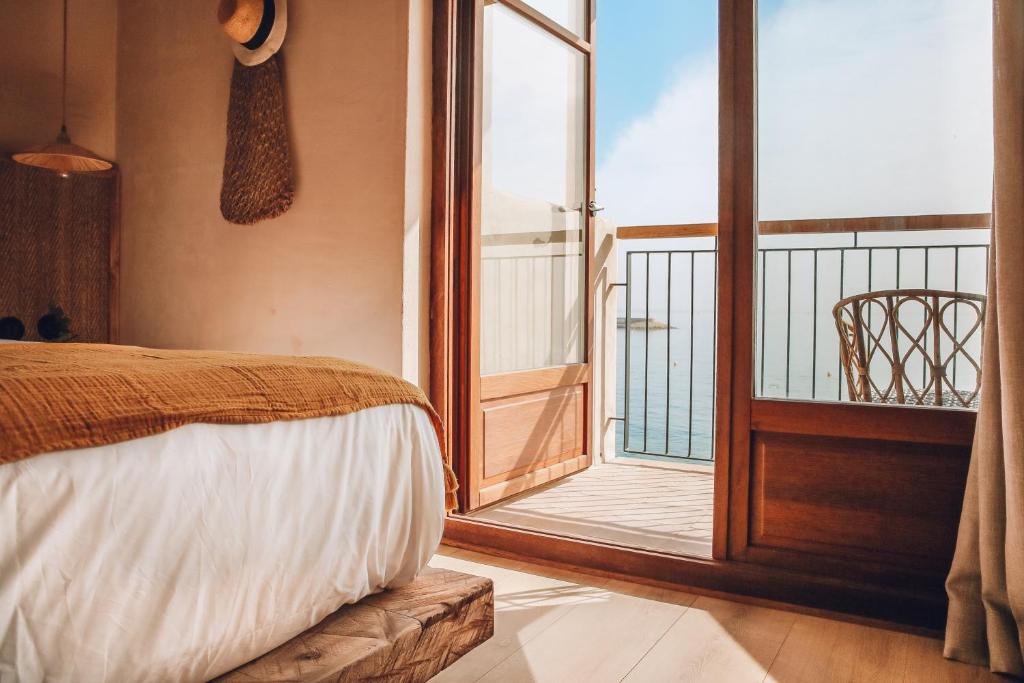 a bedroom with a bed and a balcony at Nomad Hotel - Xábia Port in Jávea