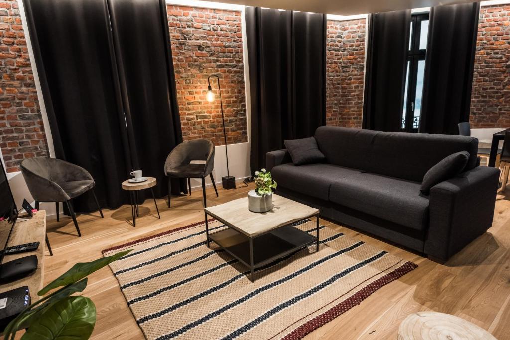 a living room with a couch and a table at Smartflats - Bourse Brussels in Brussels