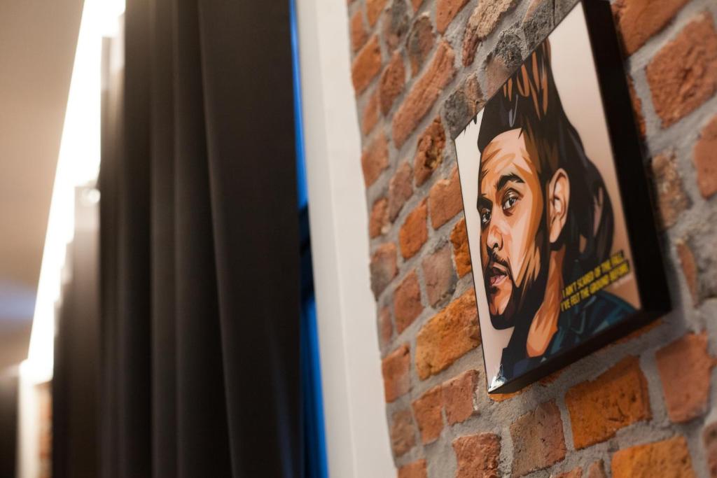 a painting of a woman on a brick wall at Smartflats - Bourse Brussels in Brussels